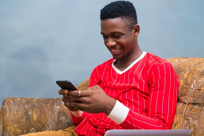 Man using phone sitting on couch