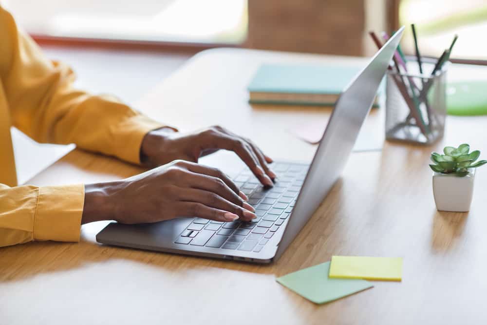 Cropped,Photo,Portrait,Of,African,American,Woman's,Hands,Typing,On